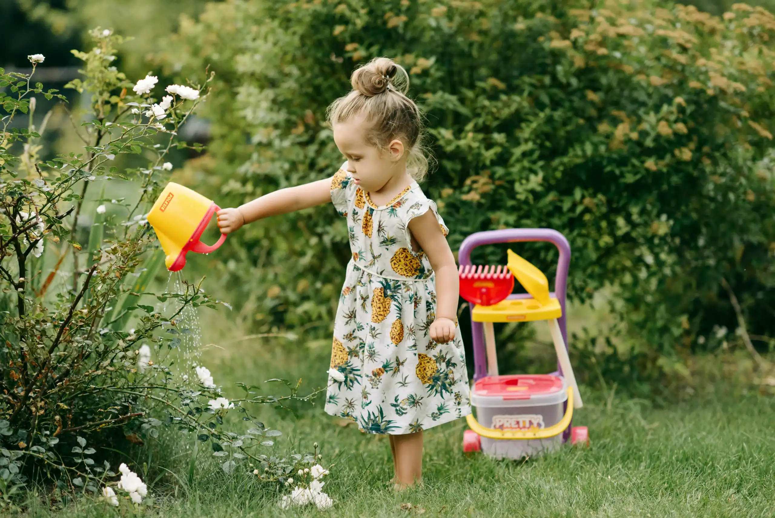 chores for toddlers – toddler placing toys in basket